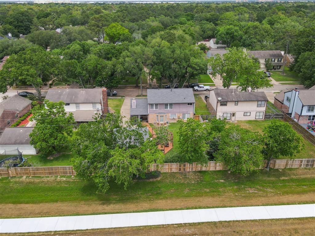 Explore this inviting home nestled among lush greenery, offering privacy and a spacious yard perfect for outdoor living.