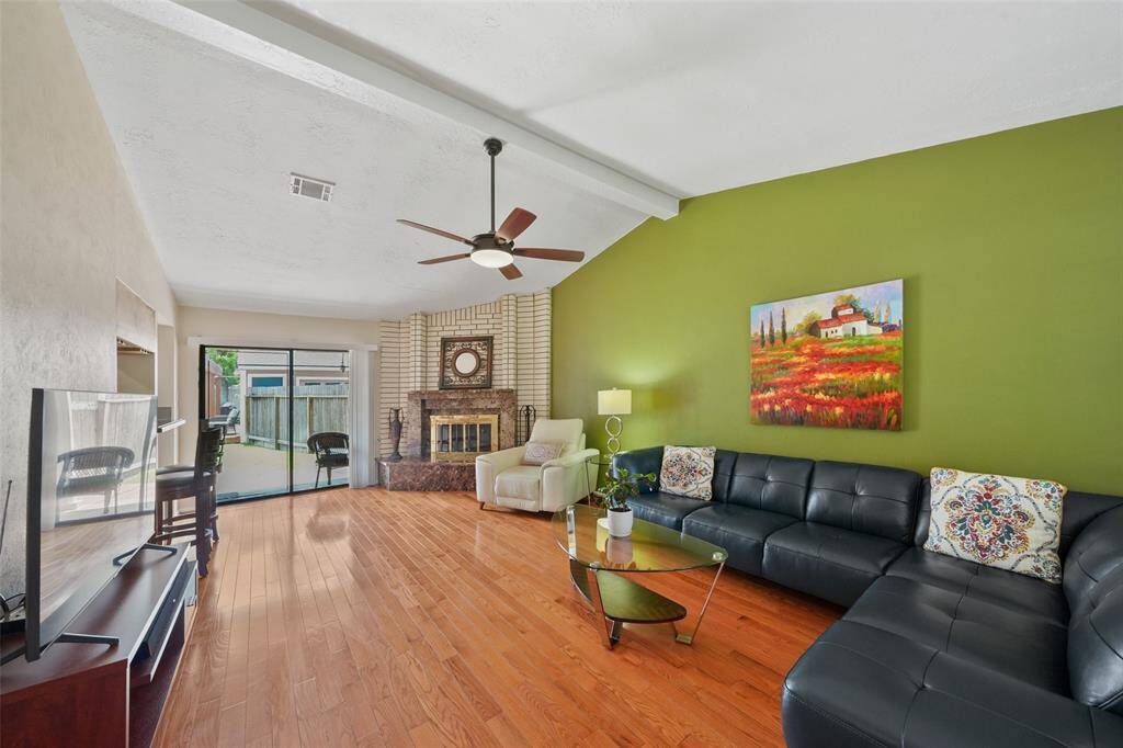 Experience the spacious and inviting family room, featuring a cozy fireplace and abundant natural light.