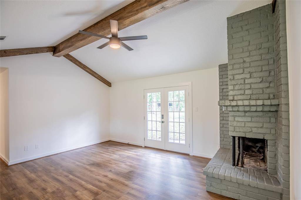 Double doors in living room lead to giant back-yard!