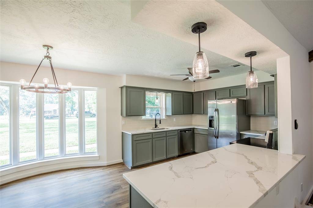 Bright and spacious kitchen opens up to breakfast area and living room.