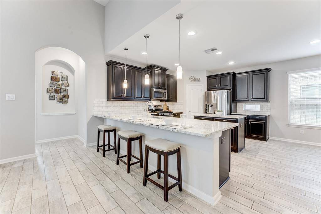 Granite counter tops, counter space galore and dark, rich cabinets. The large window lets in plenty of natural light.