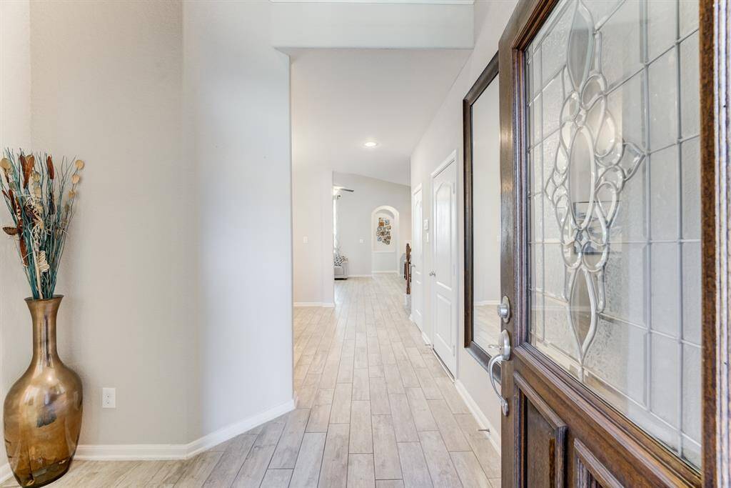 As you enter, you are greeted with a two story entryway, neutral colors and tile floors that replicate the wood look, very durable!