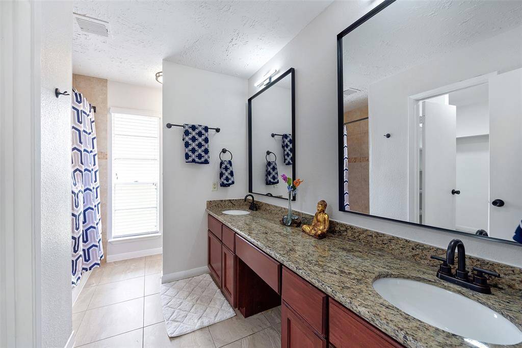 Custom built vanities with modern mirrors and fixtures.