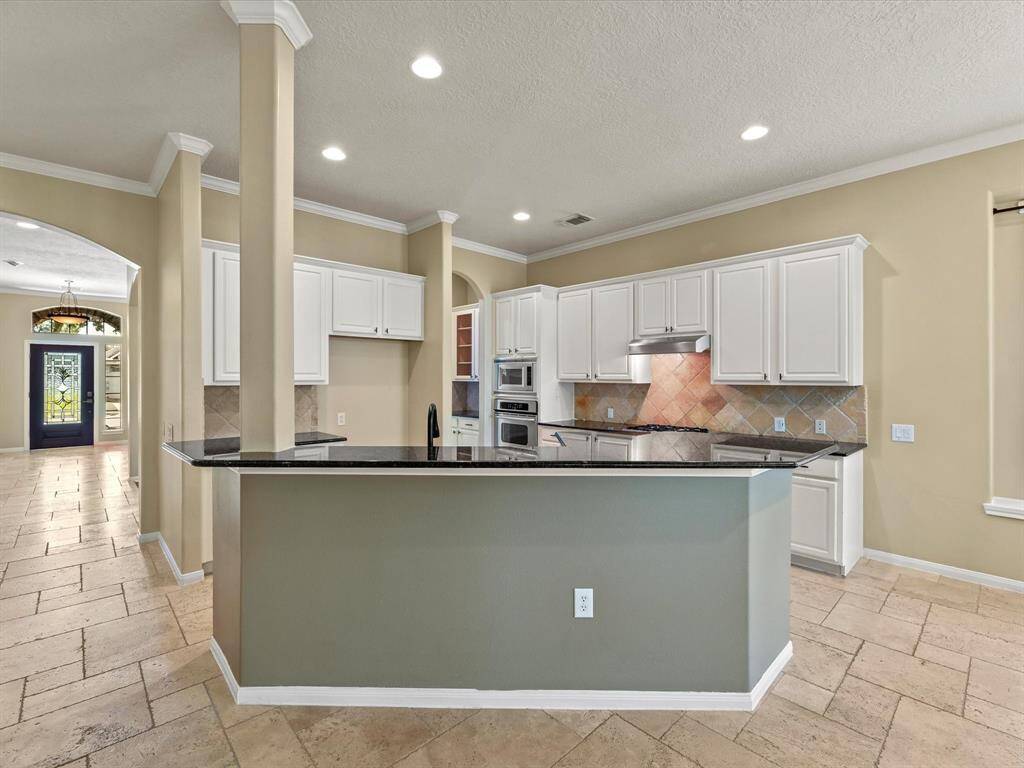 Kitchen with farmhouse sink, and open to the family room