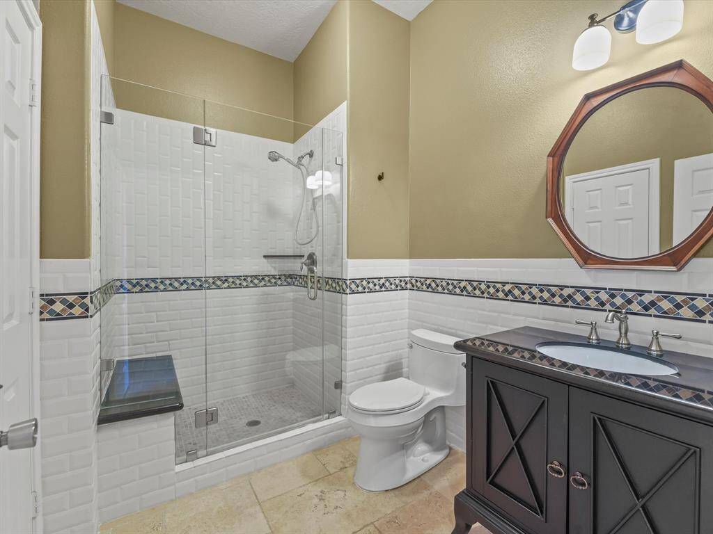 Secondary Bathroom with frameless shower and custom vanity