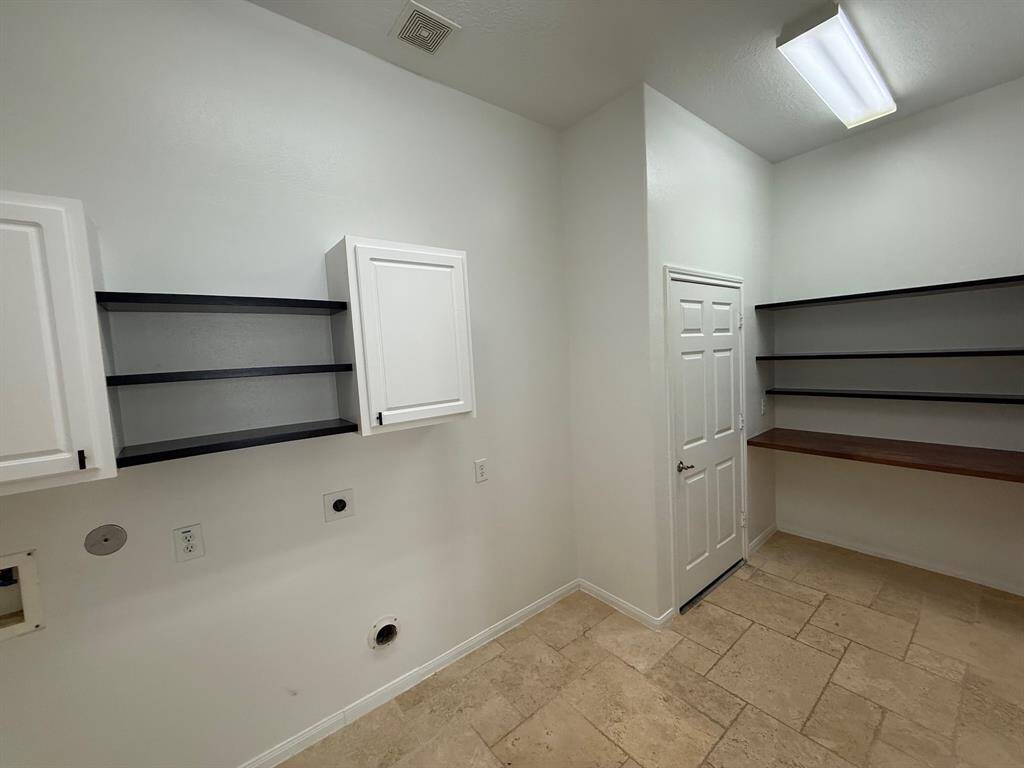 Utility room with built in cabinets and shelves