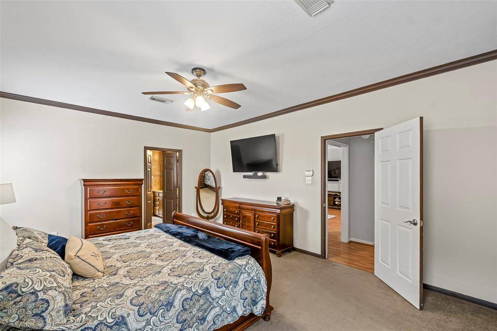 A cozy primary awaits you for a peaceful slumber!  With neutral paint and wood accents, this bedroom is ready for its new owners to enjoy.