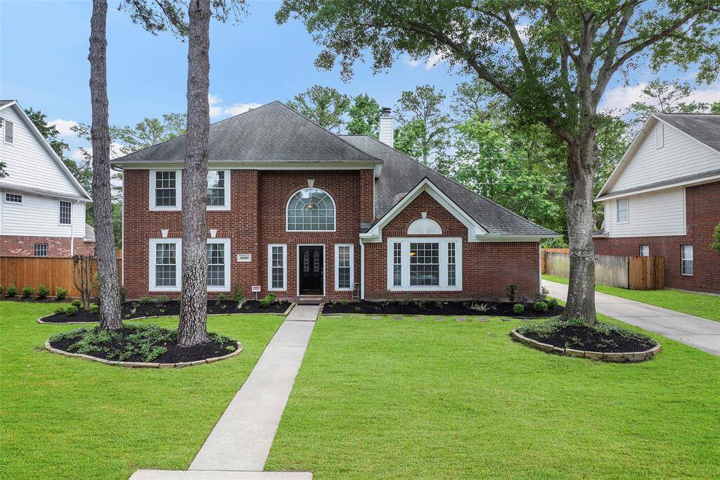 This home offers pristine curb appeal with its mature trees, fresh landscaping and the charming sidewalk that leads up to the front door!