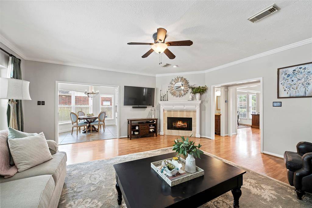 Another view of the spacious family room, shows the gorgeous wood flooring that flows from the entry, into the formal dining, study and family room in this semi-open floorplan with tons of natural light!