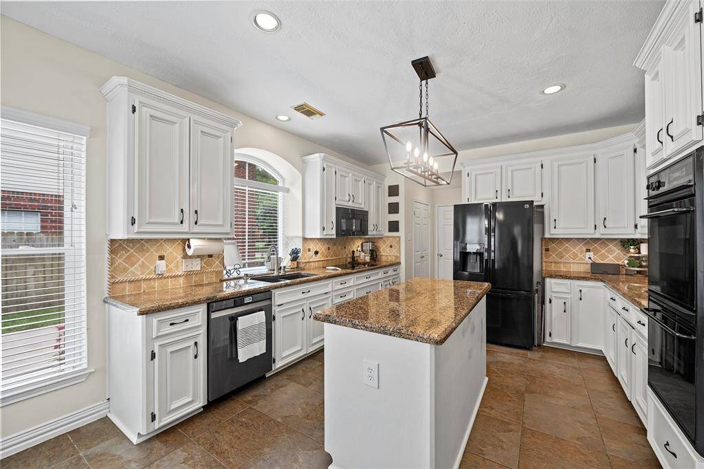 Welcome to your island kitchen, that we know will be the HUB of the home!  Crisp white cabinets with hardware, adorned with gorgeous granite countertops and custom backsplash creates a stylish but functional space!