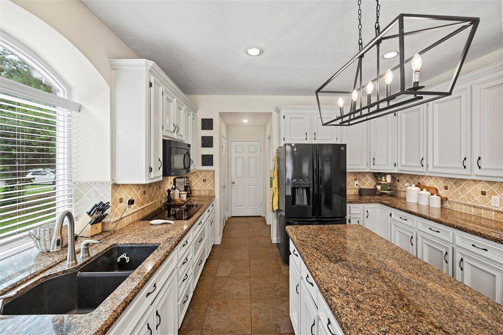 A pretty arched window perched above the kitchen sink offers a spot for growing herbs or just dreaming about things while doing the task of dishes!