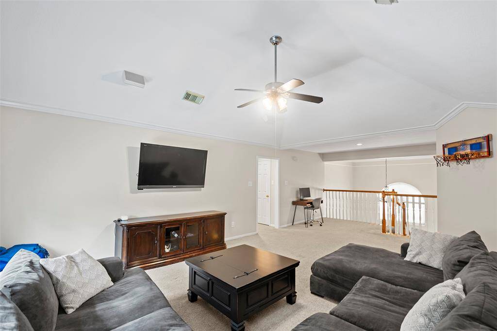 As we venture upstairs, you will find this spacious game room that is the perfect spot to sit back, relax and watch a movie with the family!