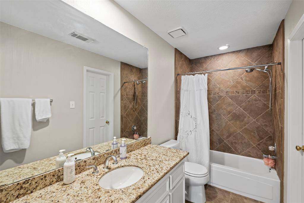 A full-sized secondary bathroom complete with vanity, granite countertops and tile surround for the shower/tub combination!