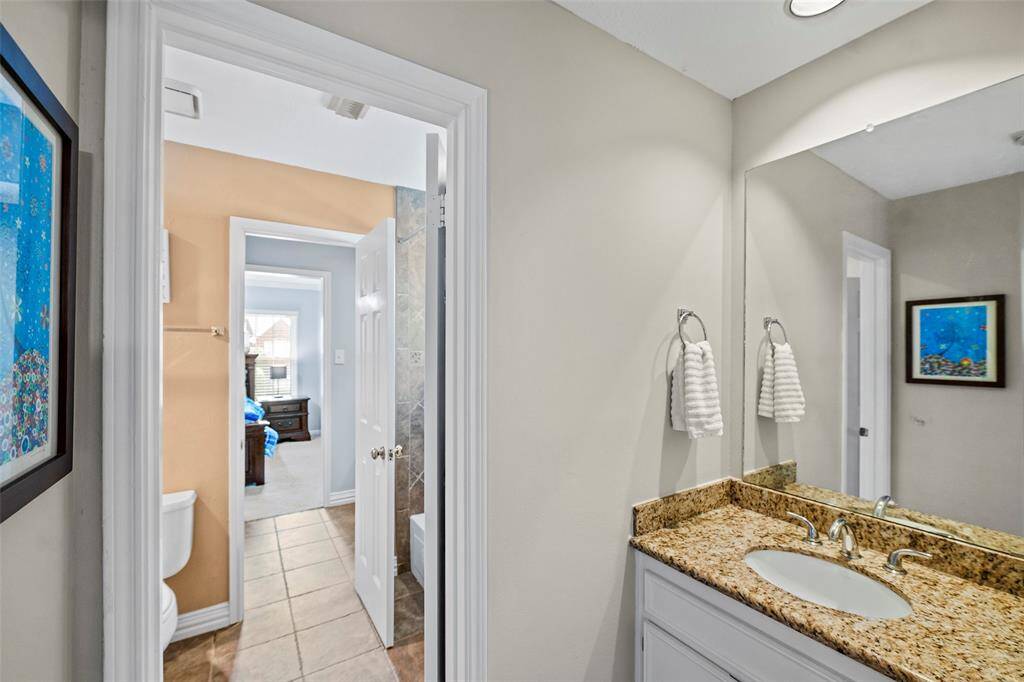 Perched between two bedrooms is this jack-n-jill bathroom. One has a vanity with wet space, and the other is a private vanity area, making morning rush hour a breeze!