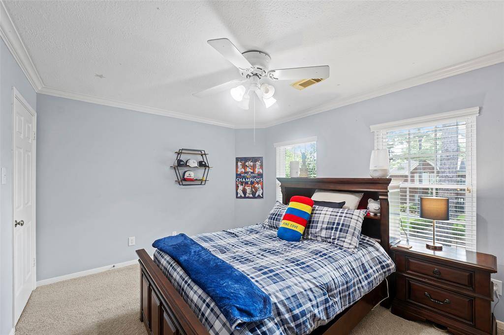Lastly, but not least is this spacious bedroom with heirloom hues, crown molding, soft carpet and tons of space!