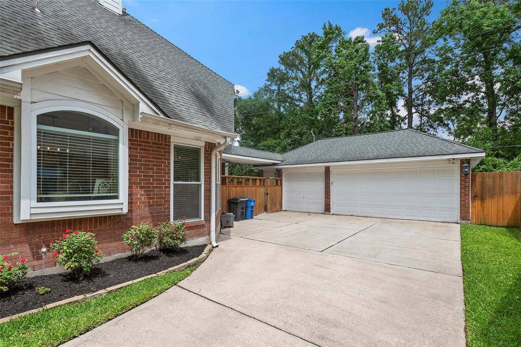 The details of a flowerbed next to the home, just outside the kitchen window is wonderful. And a wooden privacy gate keeps your backyard oasis, yours! The 3-car detached garage features extra space, cabinets and built-ins for all your storage needs!
