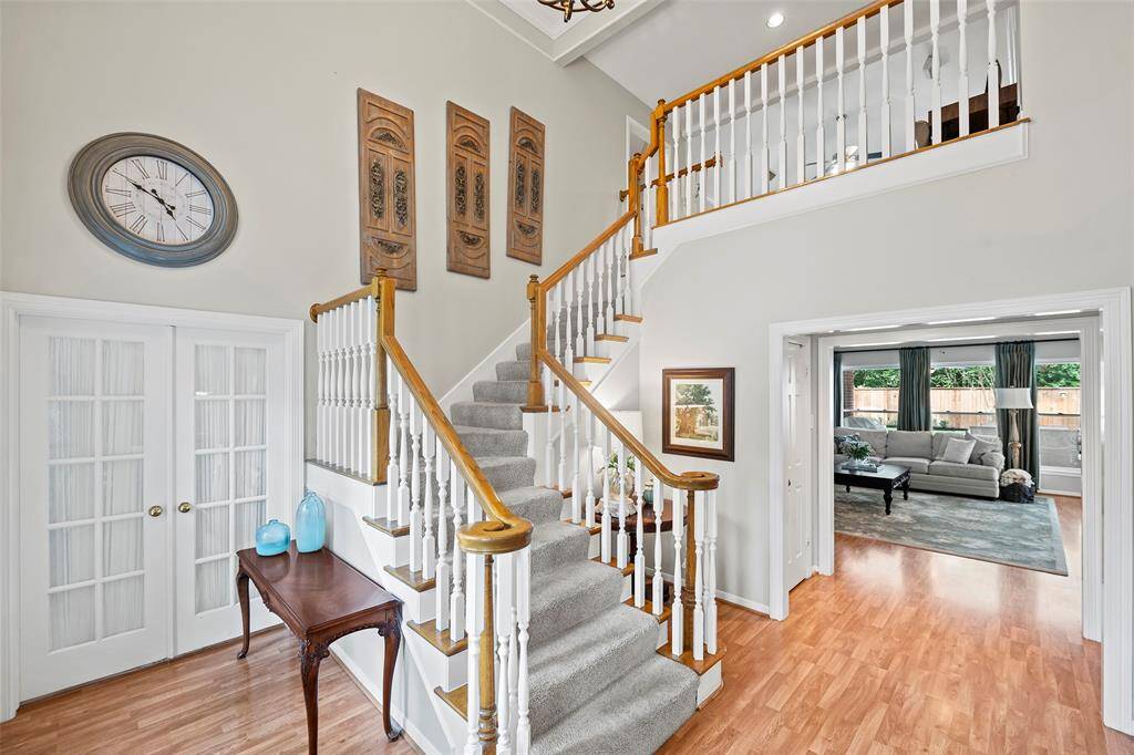 Open the door to a beautifully light and bright home with wonderful classic details, from the wood floors to breathtaking staircase, and the double French doors that add privacy!