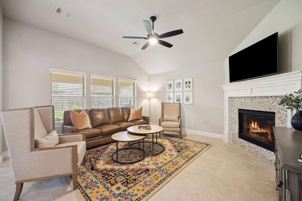 Open floorpan and spacious family room with a warm fireplace, perfect for entertaining.