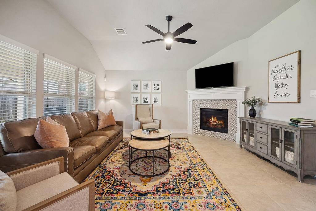 Open floorpan and spacious family room with a warm fireplace, perfect for entertaining.