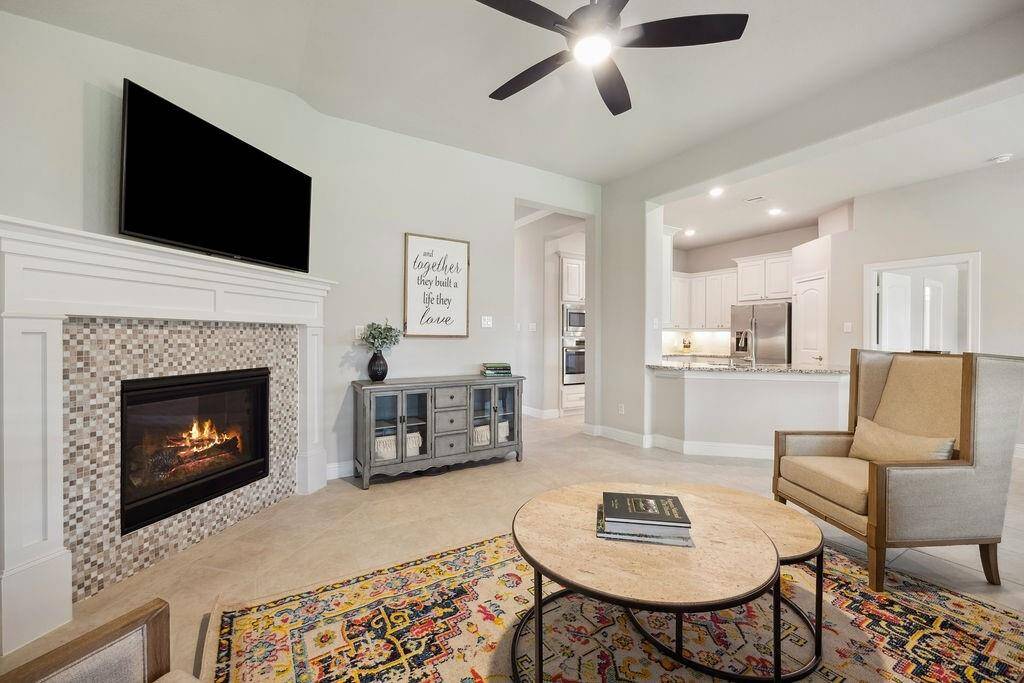 Open floorpan and spacious family room with a warm fireplace, perfect for entertaining.