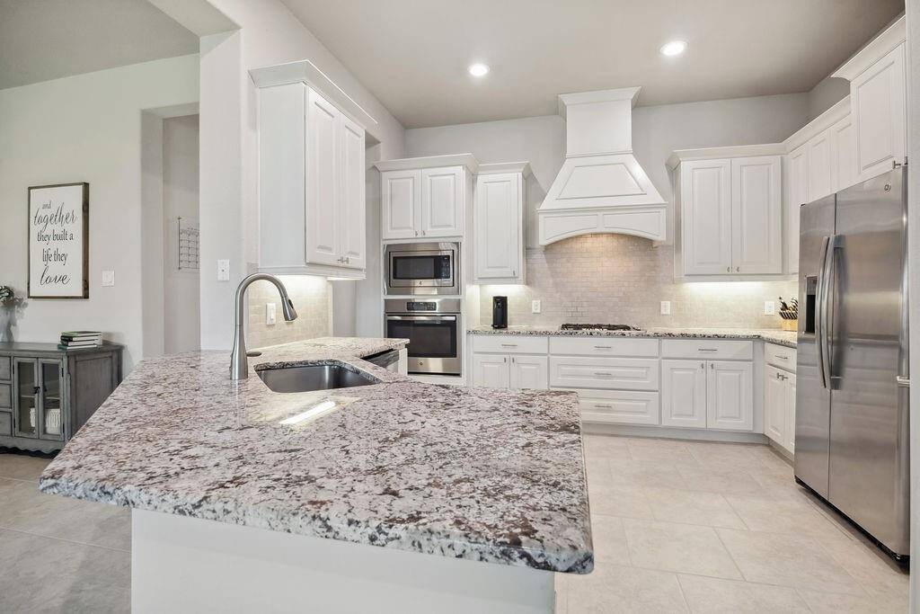 Prepping your weekly meals will be a breeze in your spacious chef’s kitchen that flows into your beautiful family room