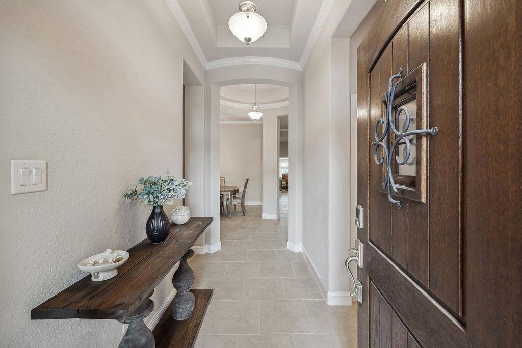 Step inside your new home and discover a charming foyer opening into a grand rotunda that sets the tone for a warm, elegant layout.