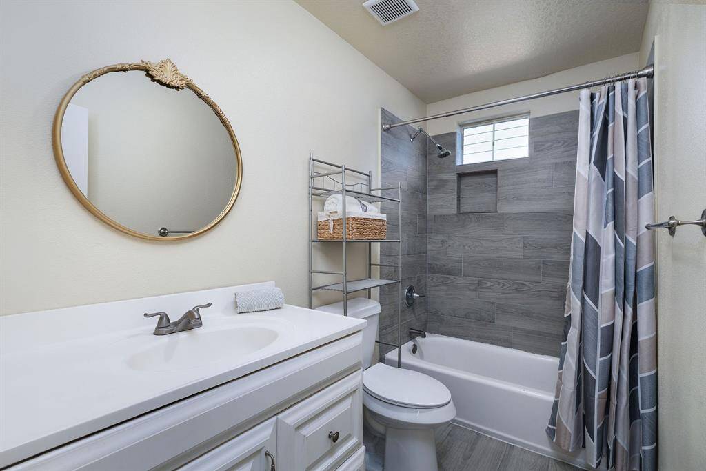 Spacious bathroom with nice tub and shower combo