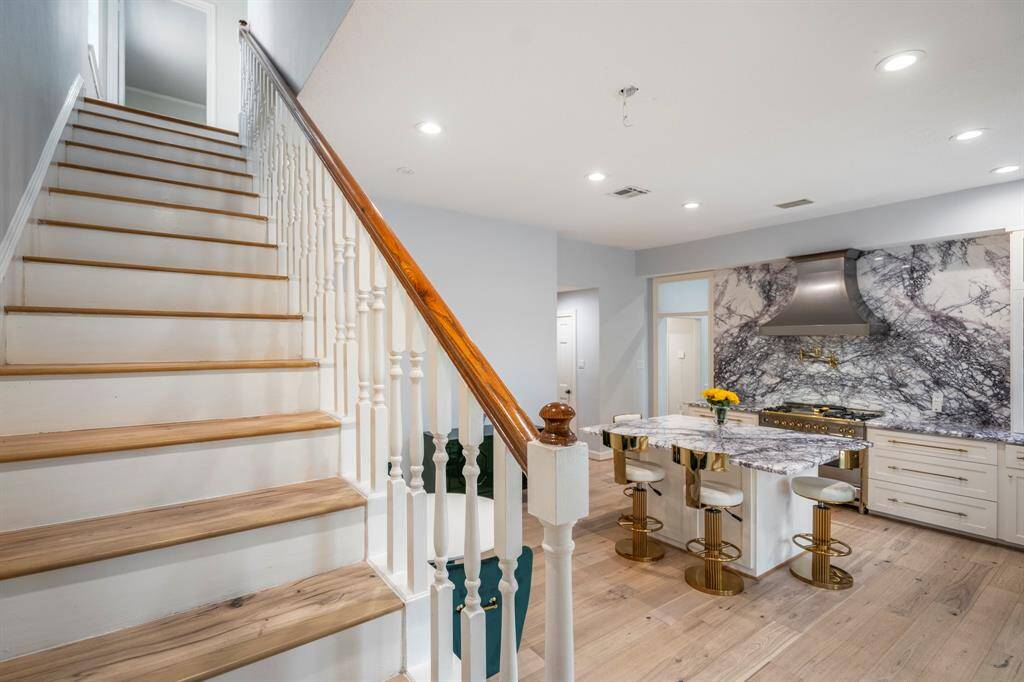 Gorgeous flooring throughout the home leads you upstairs to the bedrooms and living spaces.