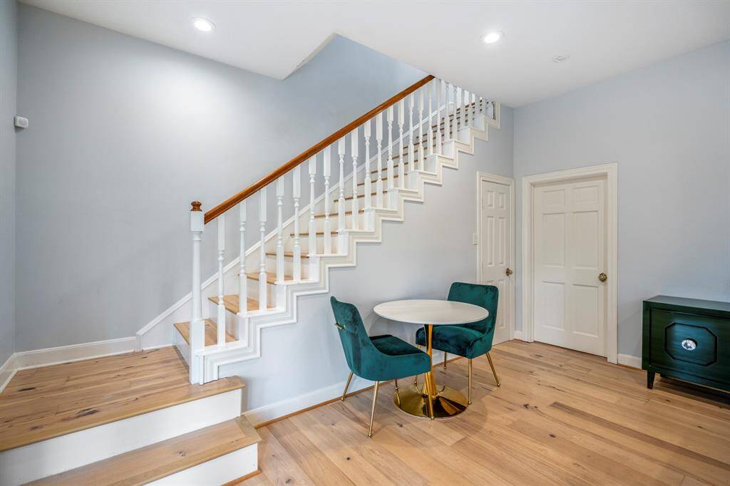 Off of the kitchen area is a large covered deck overlooking a lush backyard with trees and a swimming pool. Ideal for outdoor relaxation and entertaining.