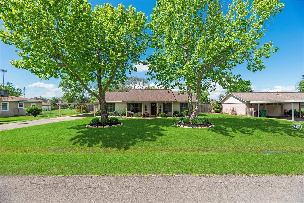 Charming single-story home with fantastic curb appeal, mature shade trees, and manicured landscaping. A wide driveway and welcoming front porch invite you in.