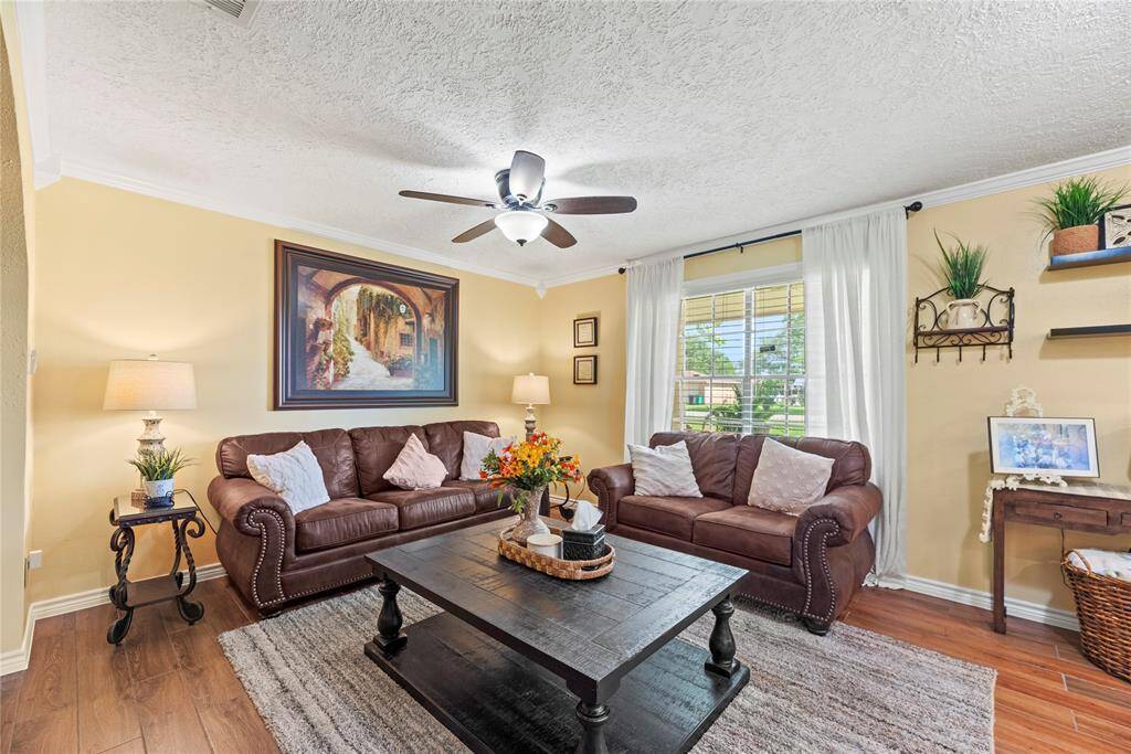 A second cozy living area with large windows and warm neutral tones, ideal for casual lounging or a quiet evening in.