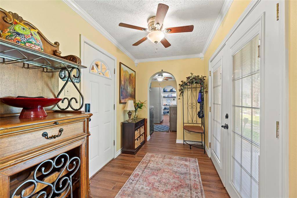 Secondary entryway with French doors to the backyard, convenient storage, and access to laundry and living areas.
