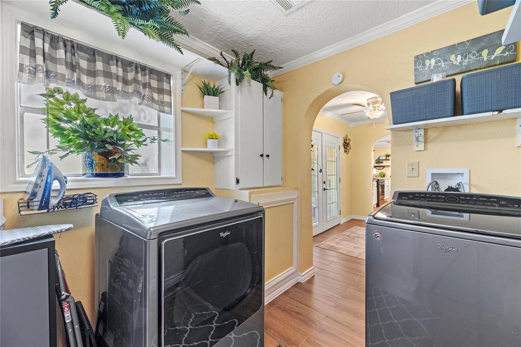 Alternate angle of the laundry room highlighting access to the backyard and charming design details.