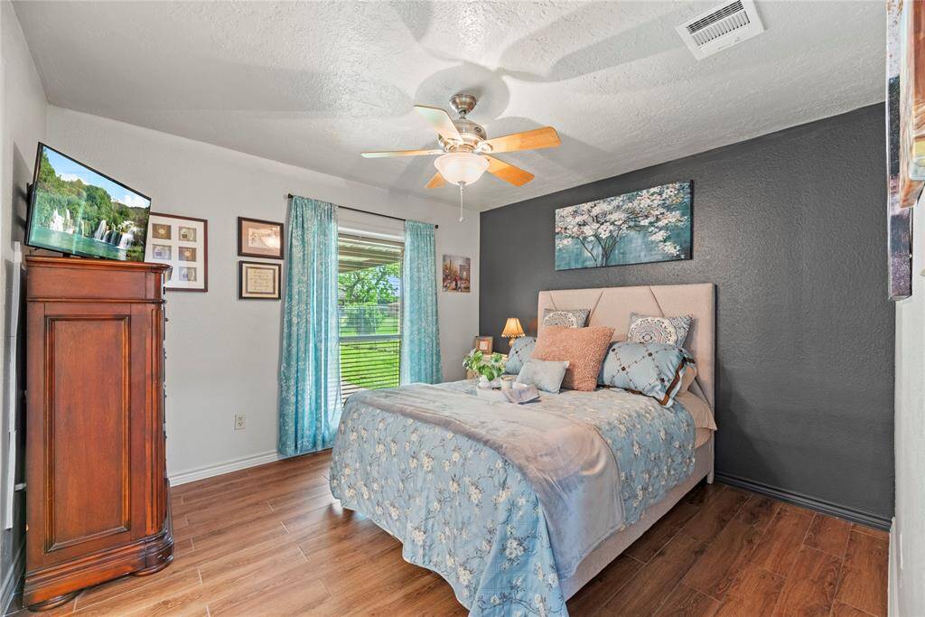 Comfortable primary bedroom with natural light, ceiling fan, and closet space—great for guests or family.