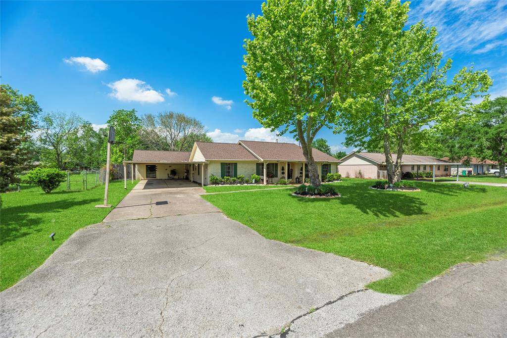 Expanded concrete driveway with carport parking and side entry. Perfect for extra vehicle space or hosting guests.