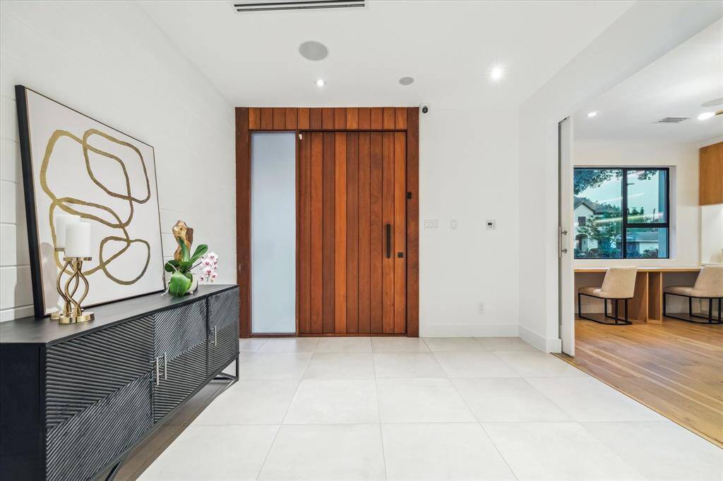 Looking back from the entry, the pivot door is equally impressive, enhancing the interior modern architecture.