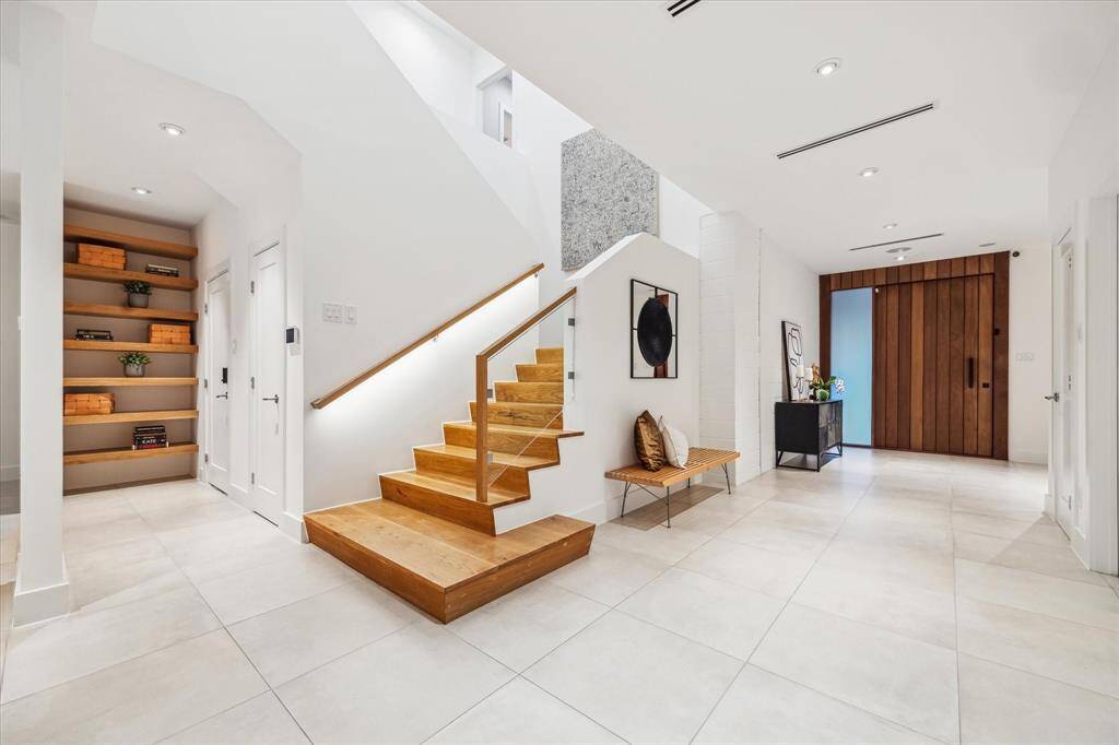 With the backdrop of white walls, the oak details throughout the home create a warm, modern contrast that adds depth and sophistication to the airy design.