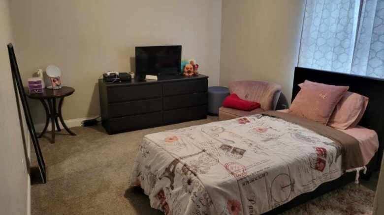 Secondary bedroom features awindow and carpet.