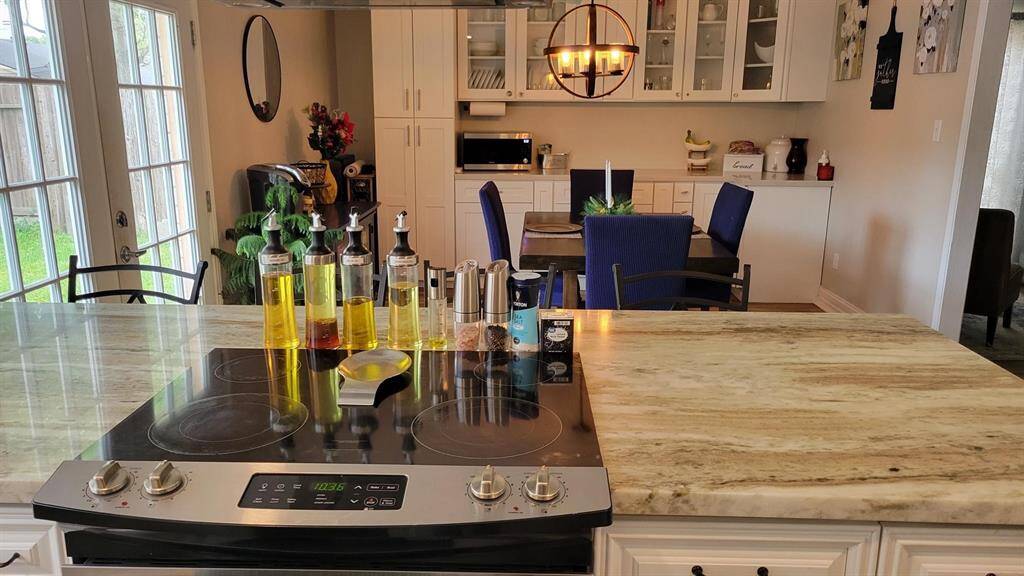 The kitchen has an island with cooktop.