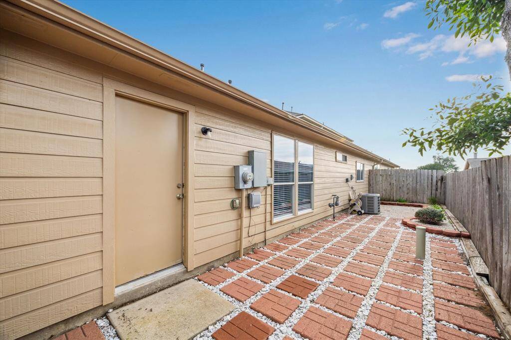A view of the rear courtyard. The exterior elevation has low maintenance cement board siding.