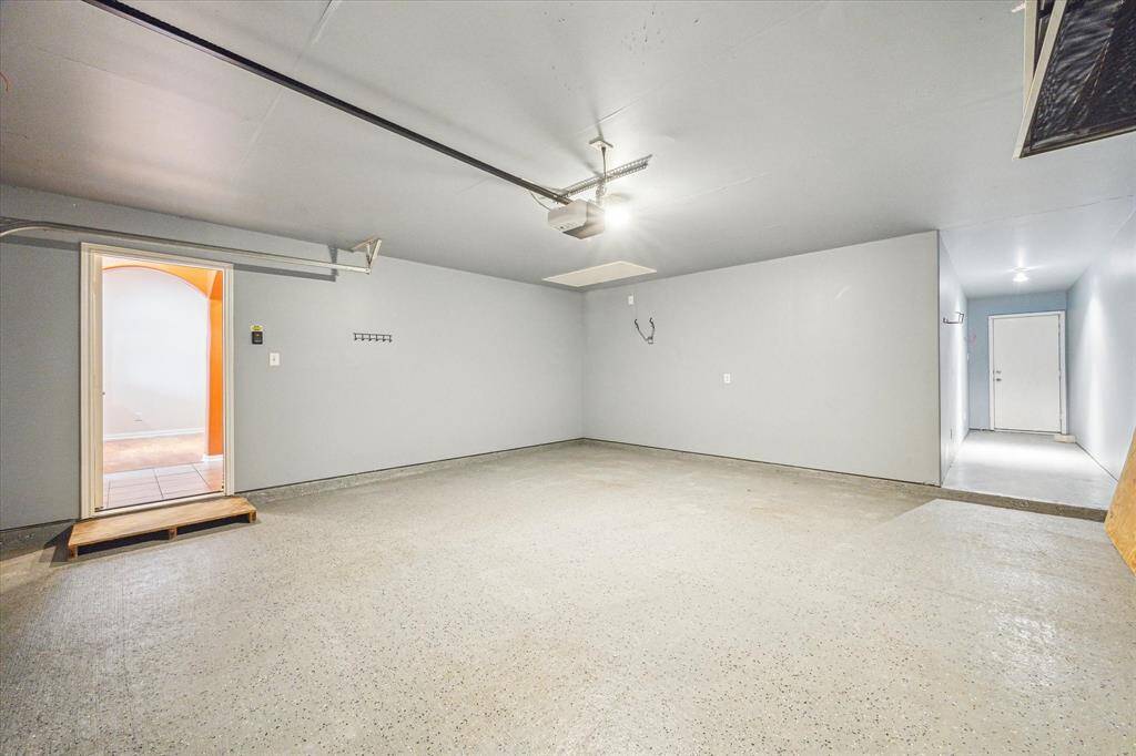 The 2-car attached garage has access to the back courtyard, garage door opener and epoxy coated floor.