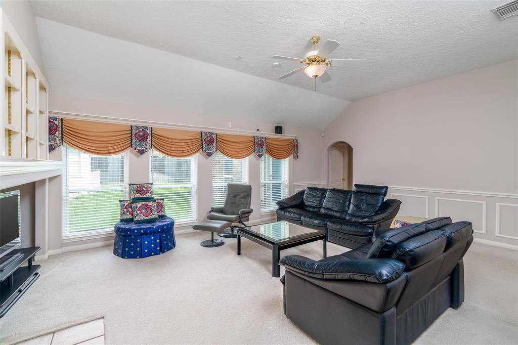 Family room with view of the backyard and corner fireplace