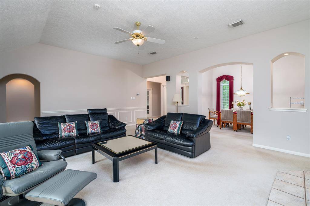 Family room with front door and dining room in the background