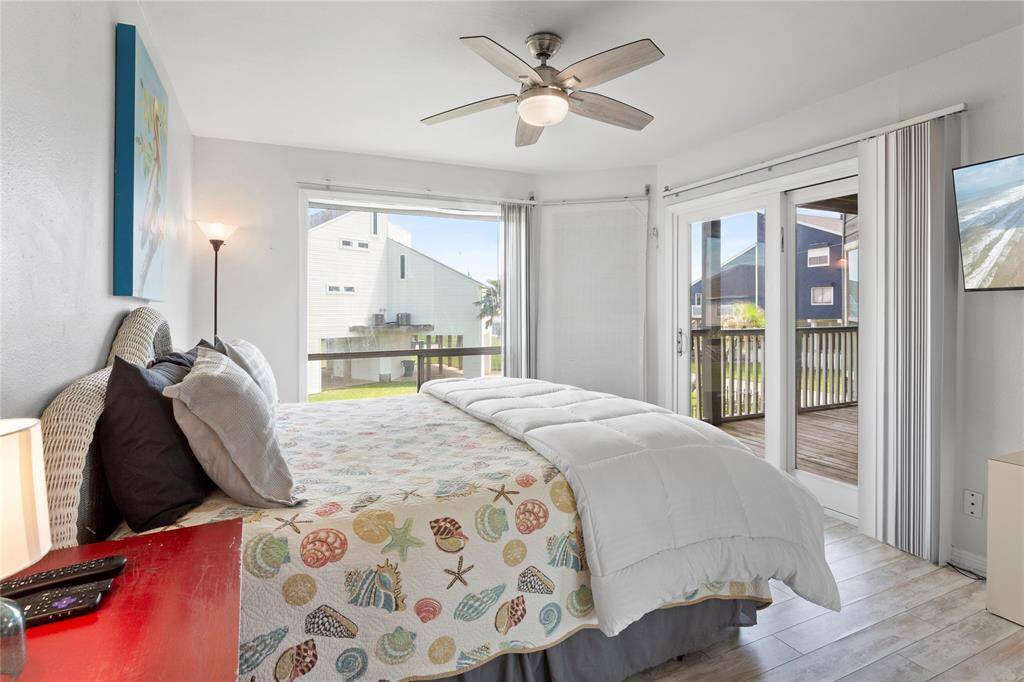 King bed in primary with balcony deck offering water views and some gulf views from windows too!