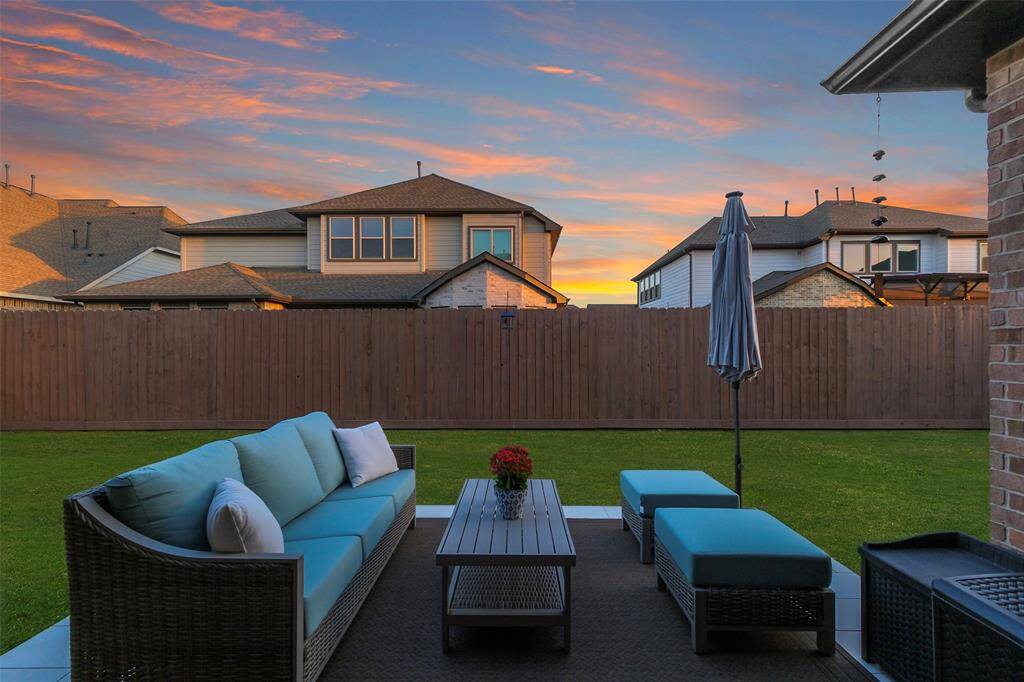 The back yard features an extended patio, a large covered patio area and recent fence.