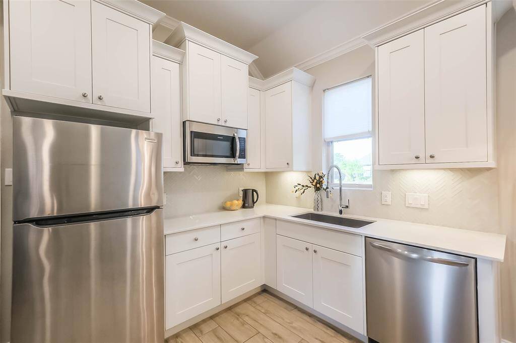 The guest suite features the SAME FINISHES AS THE MAIN KITCHEN and has full size appliances, all of which convey with the home.