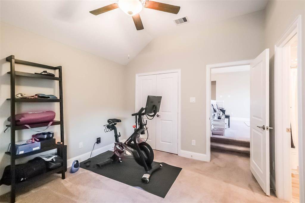 One of the three upstairs secondary bedrooms. This one is located a few steps off of the gameroom and features an ensuite bathroom. All rooms have a ceiling fan.