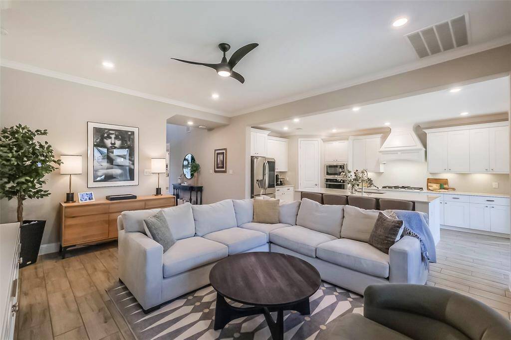 The bright and spacious living area features an open floorplan, wood-look tile flooring and a clean color palate that matches your design style.