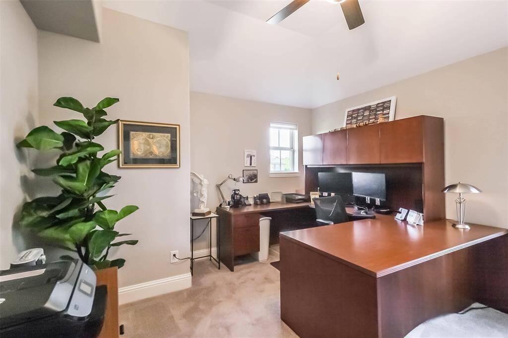 The largest of the three upstairs bedrooms which is currently being used as a home office.