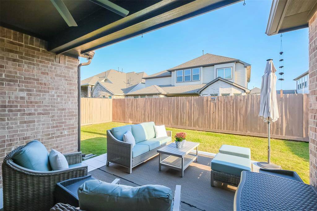 View of the covered patio over the extended tiled patio. You’ll appreciate the ceiling fan here!